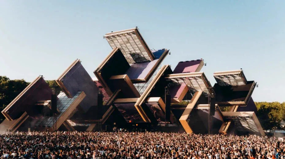 Awakenings Festival main stage with large geometric structures and a massive crowd under a clear sky.