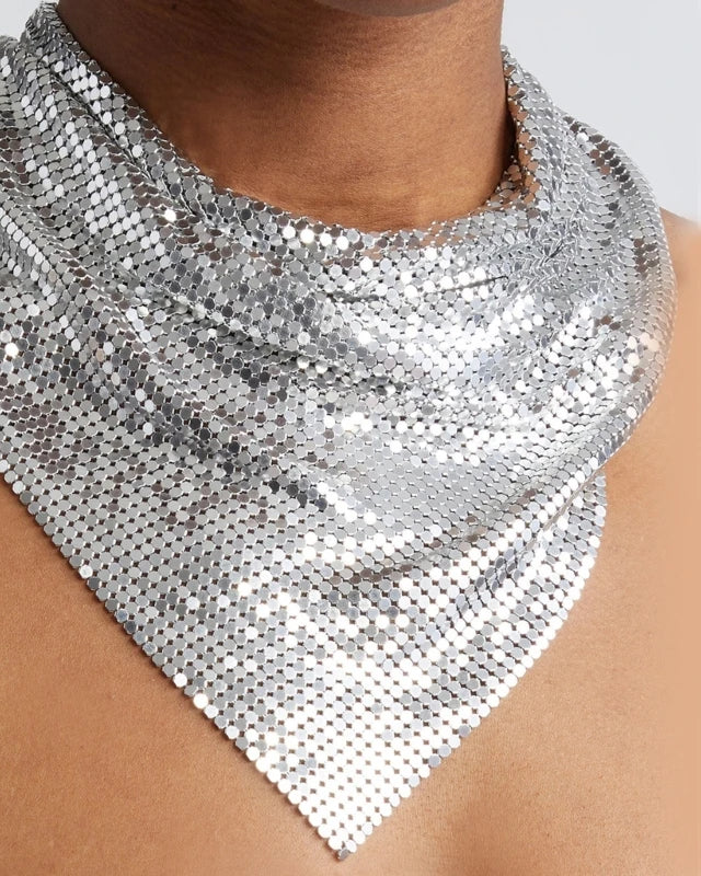 Silver liquid metal mesh scarf, triangular bib style, draped on a neck and chest.