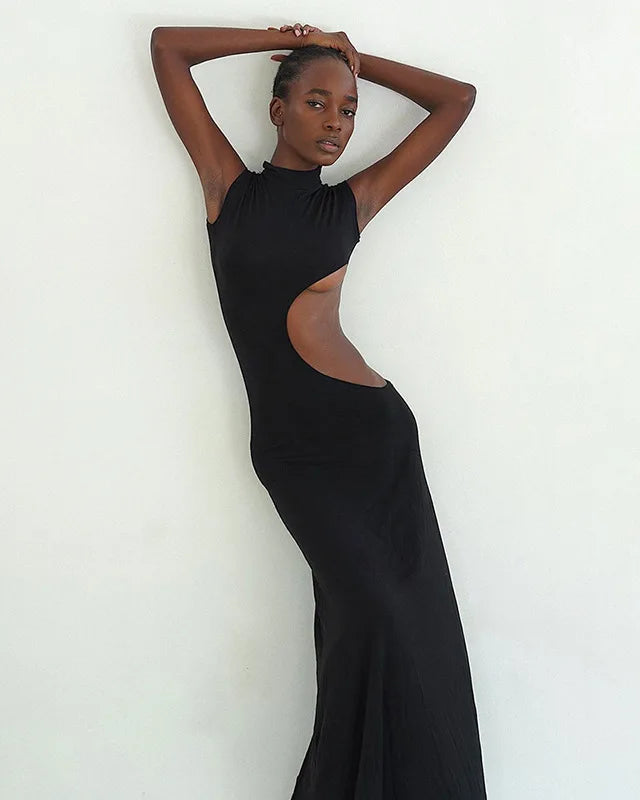 Model showcasing a sleek Cut Out Maxi Dress with high stretch polyester and playful cut outs.
