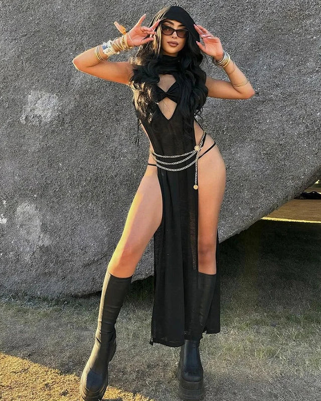 Model wearing a Black Knitted Hooded Long Dress with a stylish hood and boots at a festival.