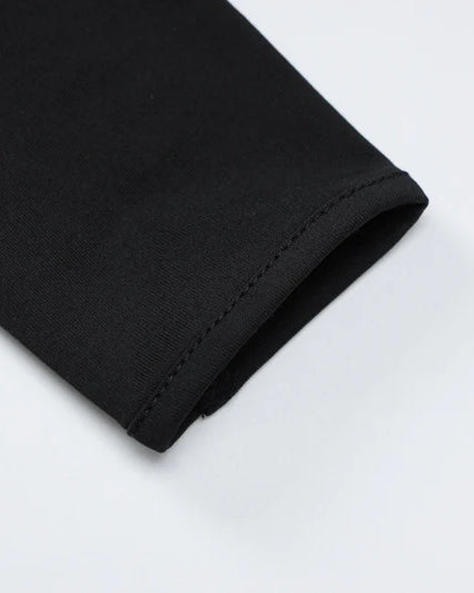 Close-up of the sleeve of a Black Long-Sleeve See-Through Bodysuit highlighting its fabric.