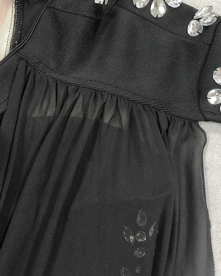 Rhinestones Bodysuit with Cape showcasing rhinestone embellishments and flowing fabric details.