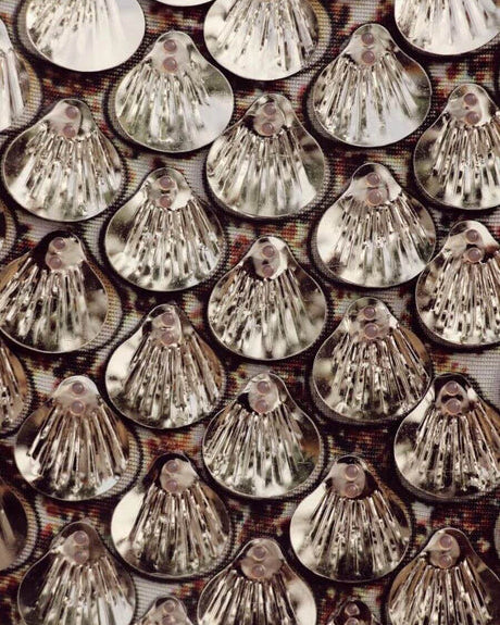 Close-up of shimmering silver sequins on fabric, perfect for a Champagne Metallic Sequin Party Dress.