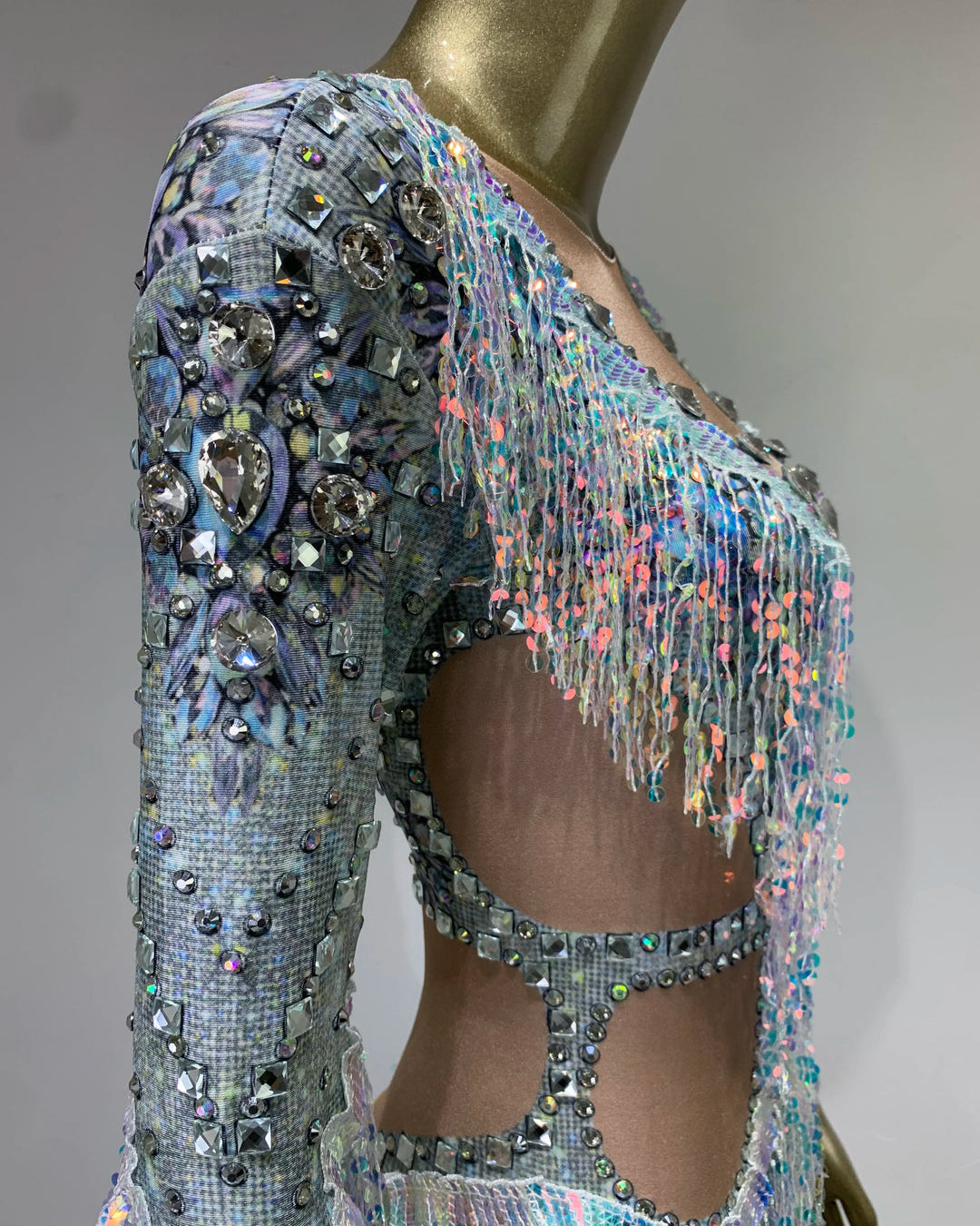 Side view of Diamond Rhinestone Tassel Bodysuit with intricate rhinestone detailing and colorful tassels.