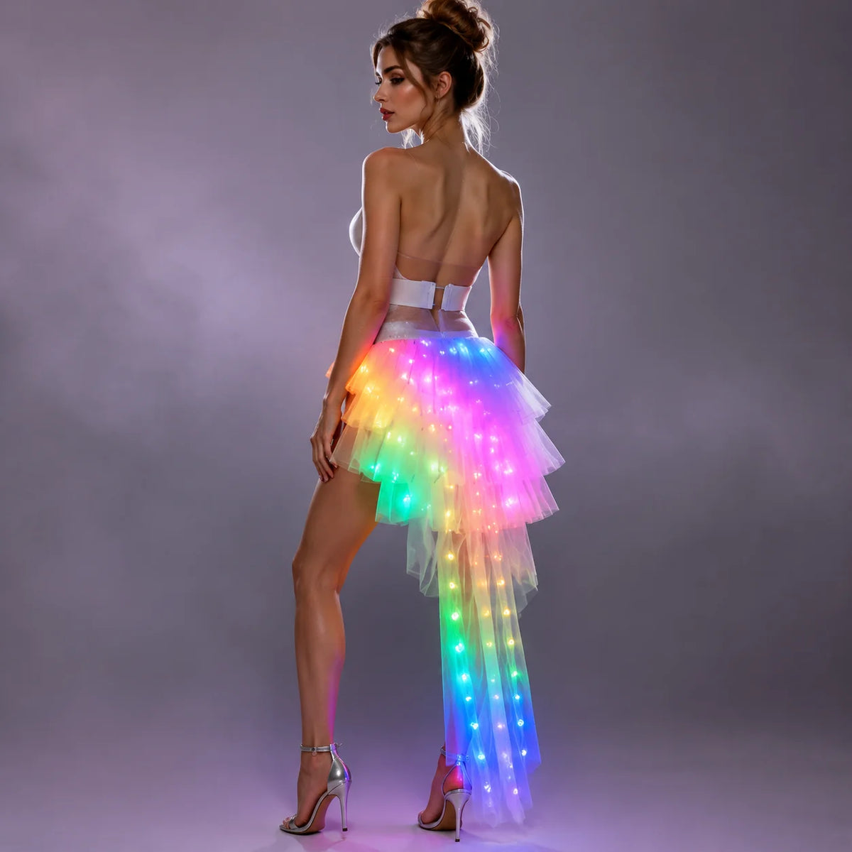 Model wearing a tiered white tulle LED long skirt with vibrant, multi-colored glowing lights and a high-low silhouette.