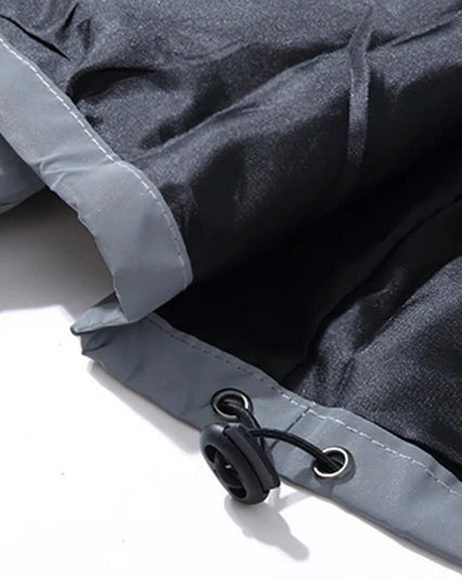 Close-up of the Grey Reflective Festival Jacket's fabric and adjustable drawstring detail.