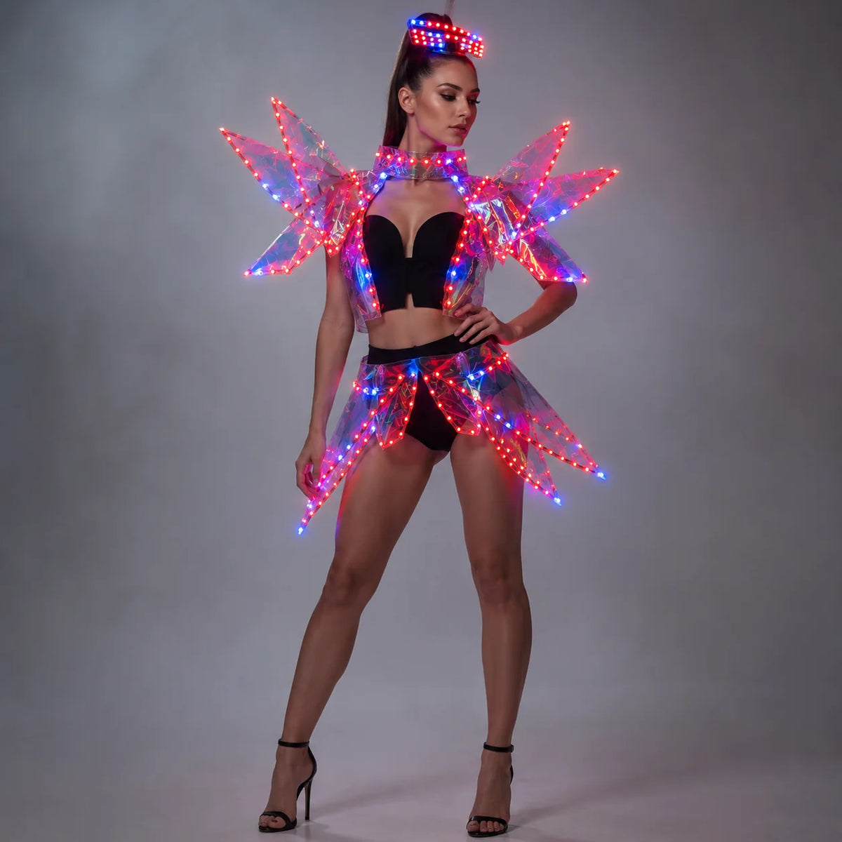 Futuristic LED costume with a glowing acrylic visor and light-up structural wings in red and blue on a gray background.