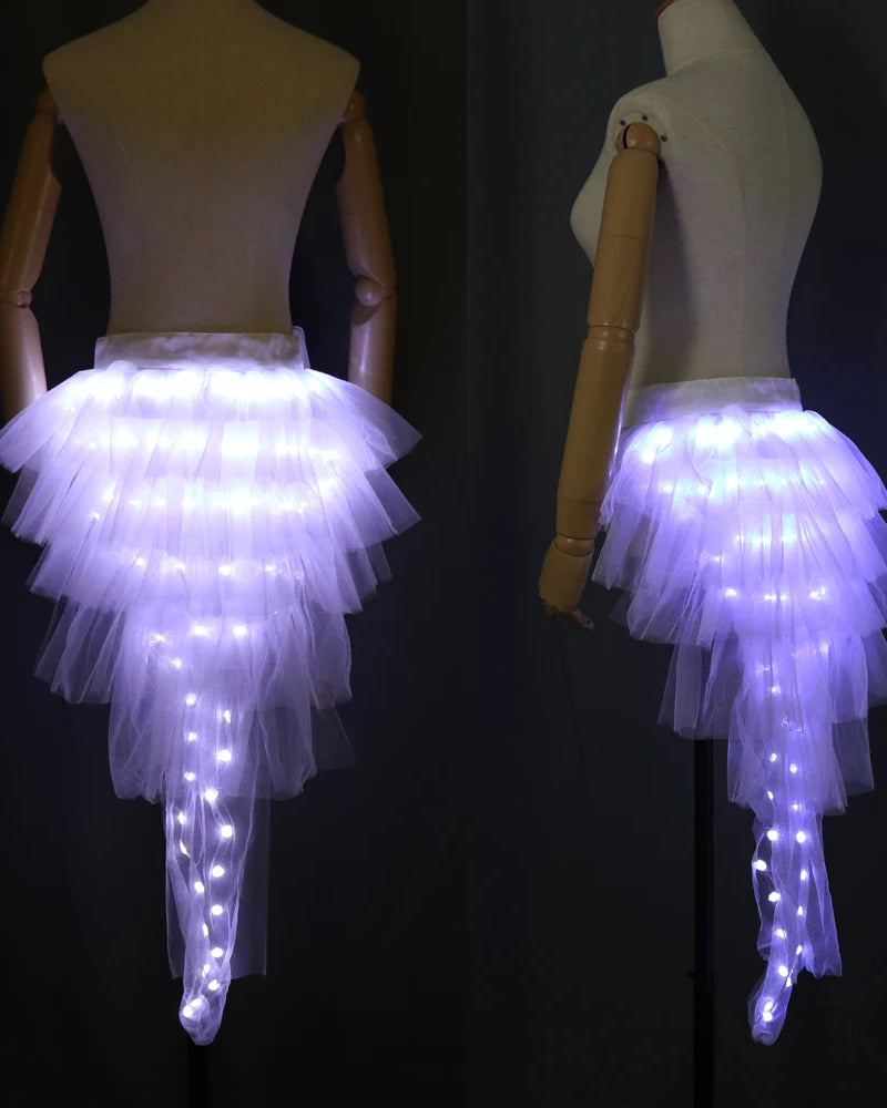 White layered tulle tutu skirt with integrated glowing LED lights on a mannequin, shown from back and side angles.