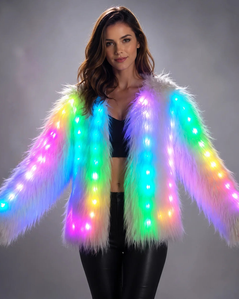 Woman wearing a plush white faux fur jacket featuring integrated, multi-colored LED lights for a vibrant festival look.