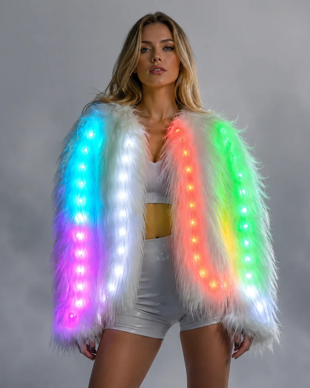 Model wearing a plush white faux fur jacket featuring integrated, multi-colored LED light strips.