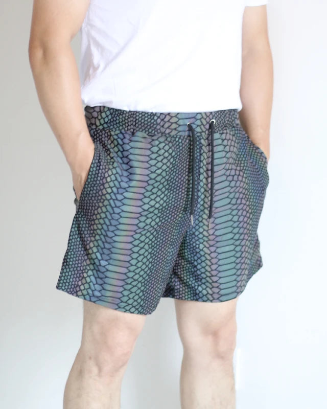 Men's reflective festival shorts with a snakeskin pattern, black drawstring, and side pockets.