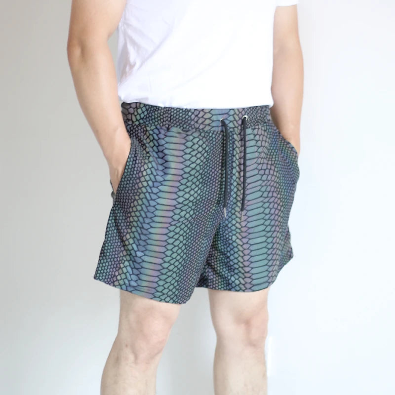 Men's reflective festival shorts with a snakeskin pattern, black drawstring, and side pockets.