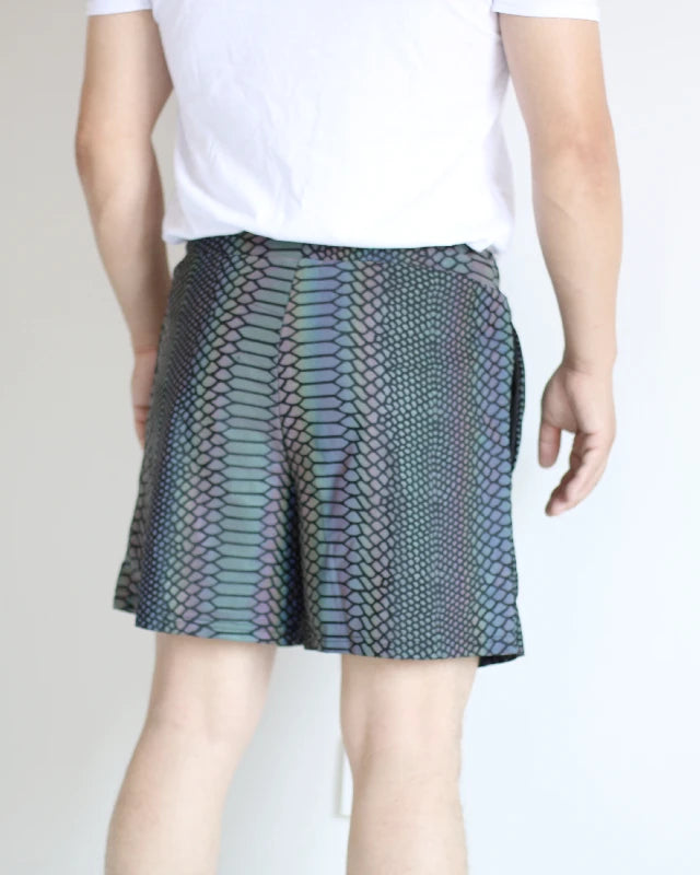 Men's reflective festival shorts with a snakeskin pattern, shown on a model from behind.