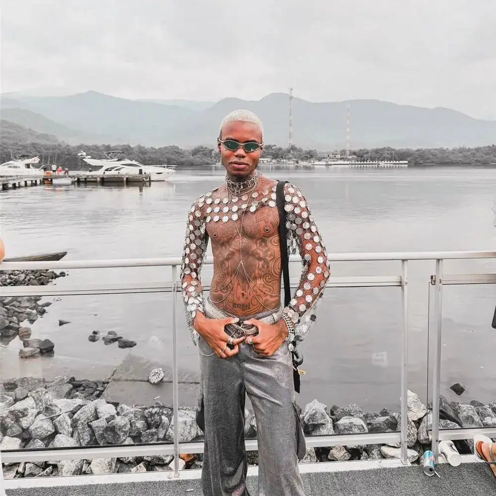 metal chain disc crop top close-up model posing by water with mountains in background