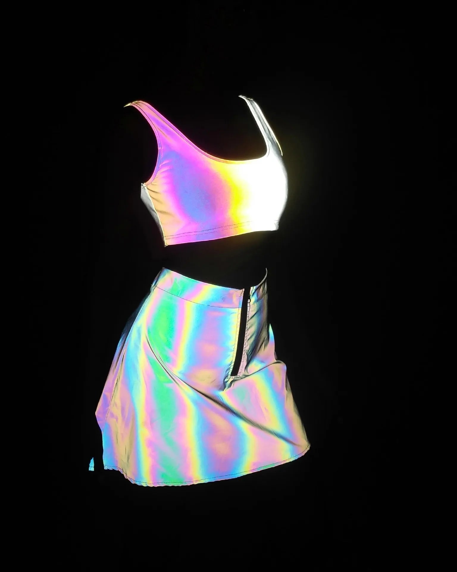 Multicolor reflective two-piece set featuring a crop top and mini skirt, shifting colors under light.