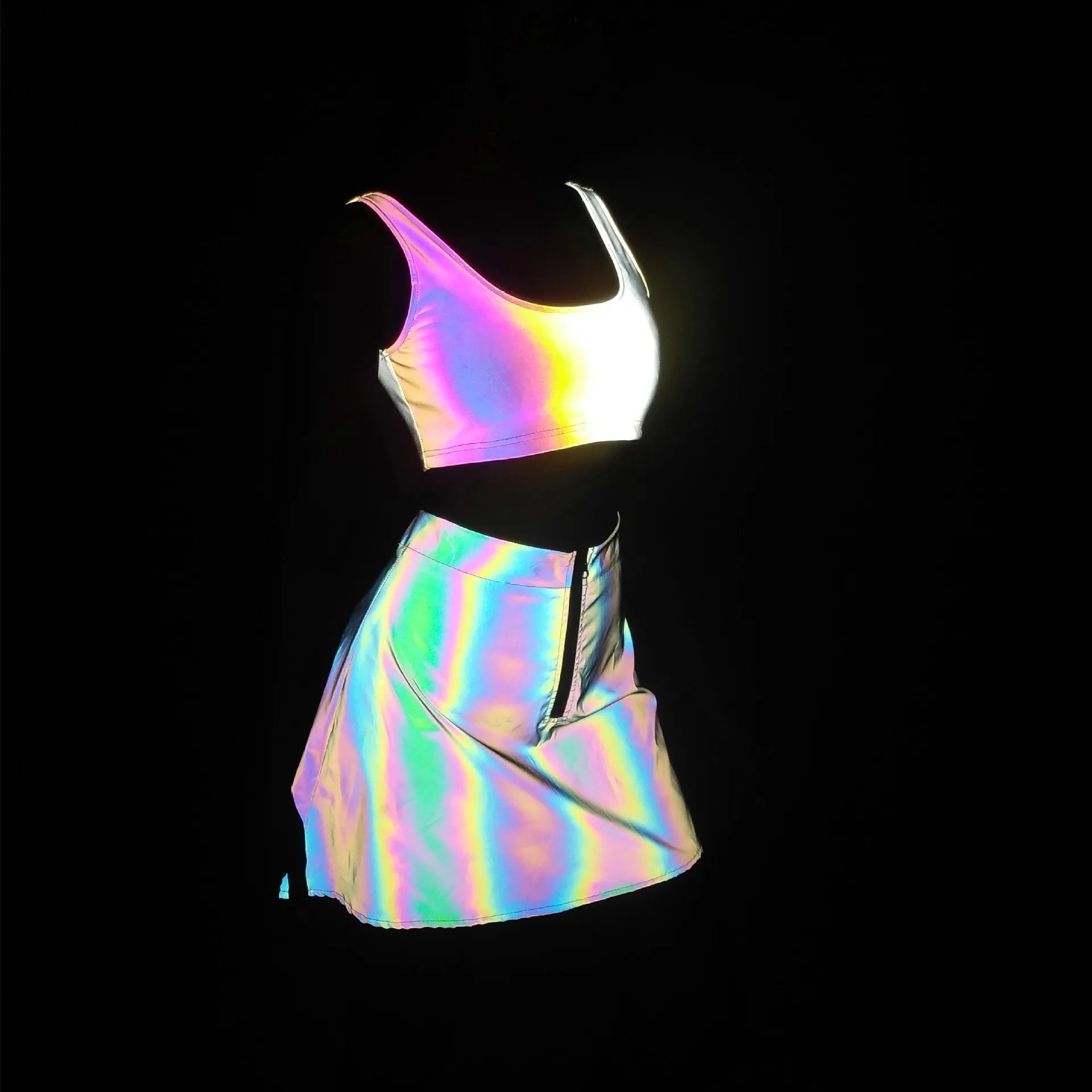 Multicolor reflective two-piece set featuring a crop top and mini skirt, glowing with rainbow brilliance.