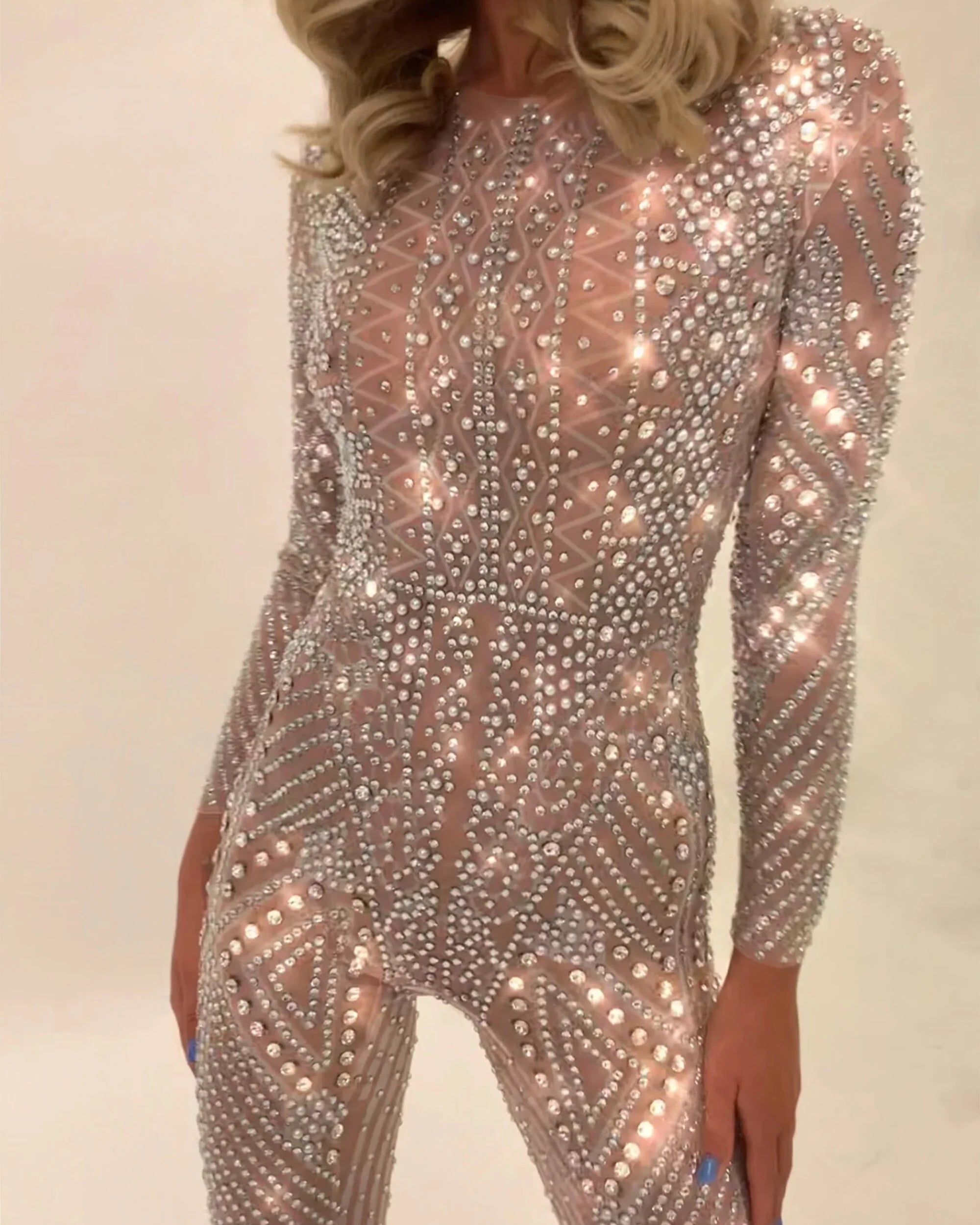 Nova Silver Rhinestone Jumpsuit, a full-coverage, long-sleeve, fitted jumpsuit with hand-glued rhinestones.