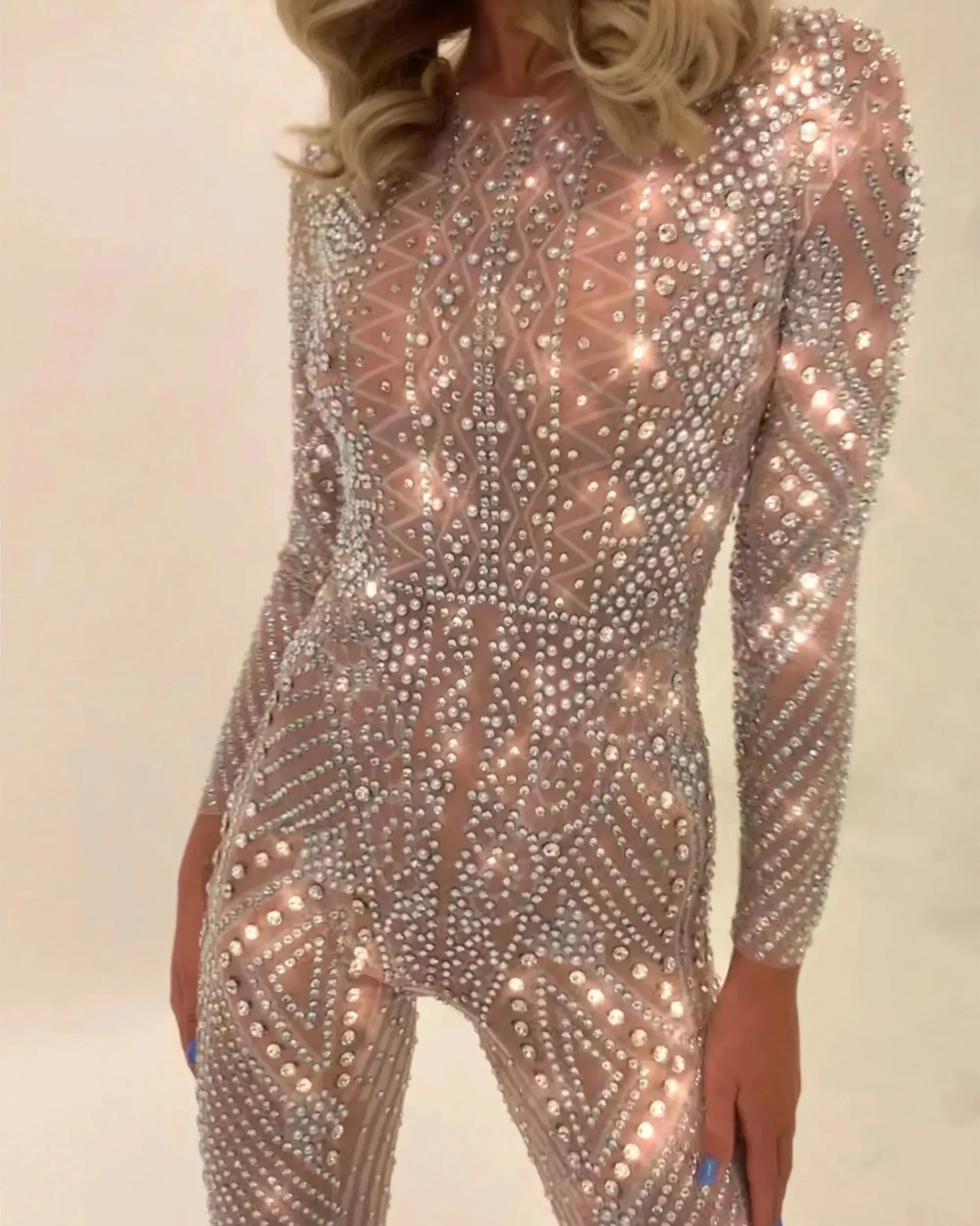 Nova Silver Rhinestone Jumpsuit, a full-coverage, long-sleeve, fitted jumpsuit with hand-glued rhinestones.