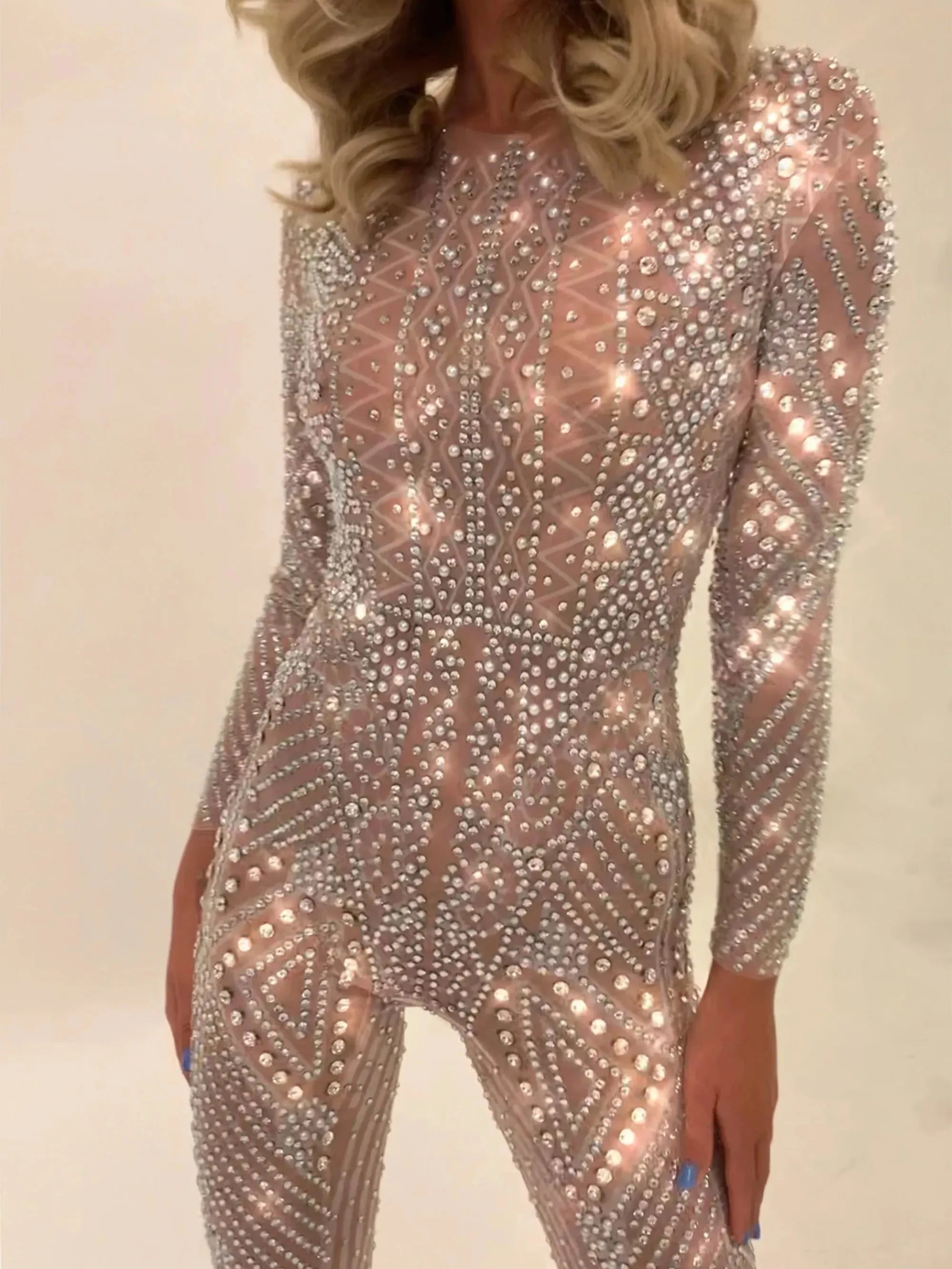 Nova Silver Rhinestone Jumpsuit, a full-coverage, long-sleeve, fitted jumpsuit with hand-glued rhinestones.