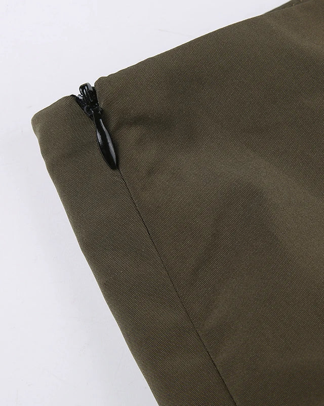 Close-up of zipper detail on green fabric, showcasing quality for Green Rave Mini Skirt.