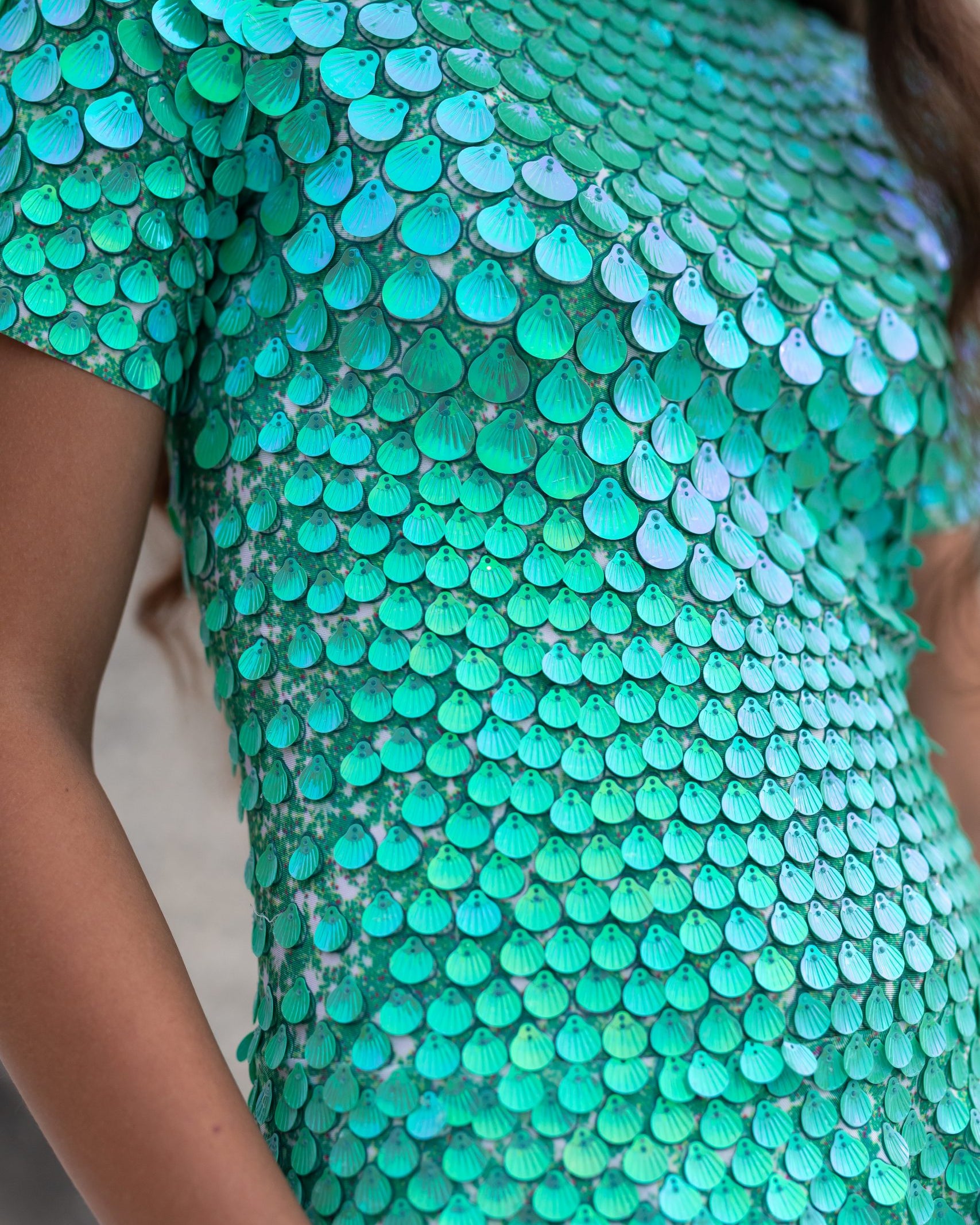 Close-up of Olivia Light Green Metallic Sequin Party Dress, featuring shell-shaped sequins and a turtleneck.