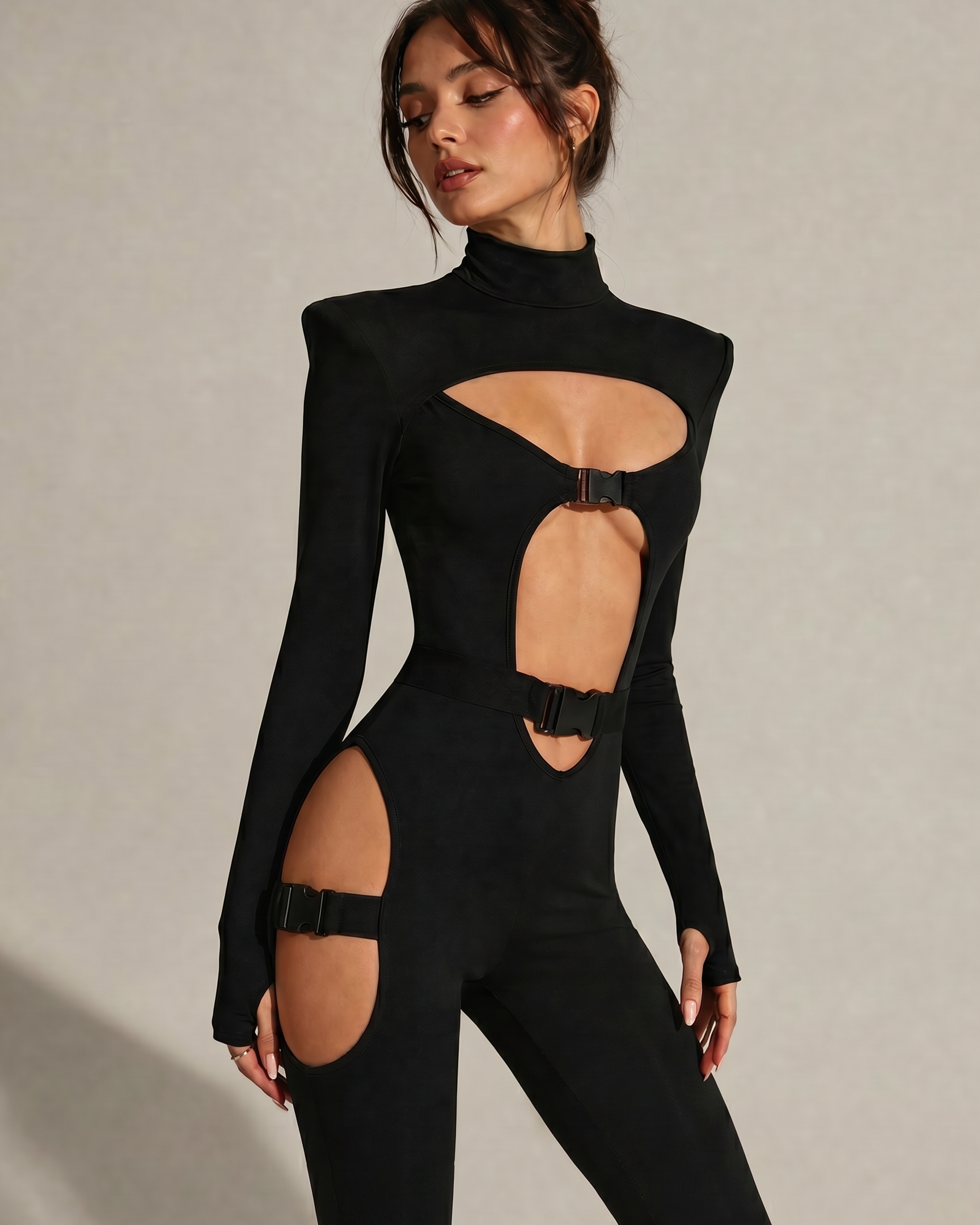 Black Cyber Gothic Sexy Bodysuit with cut-outs, metallic buckles, and high neck.