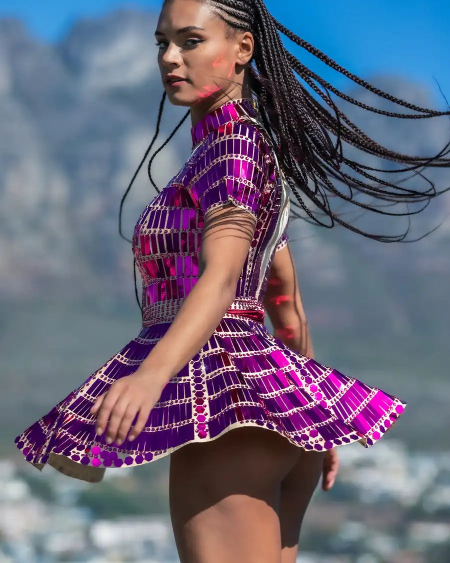 Model wearing a Sequin Rhinestone Festival Mini Dress, showcasing vibrant colors and playful movement.