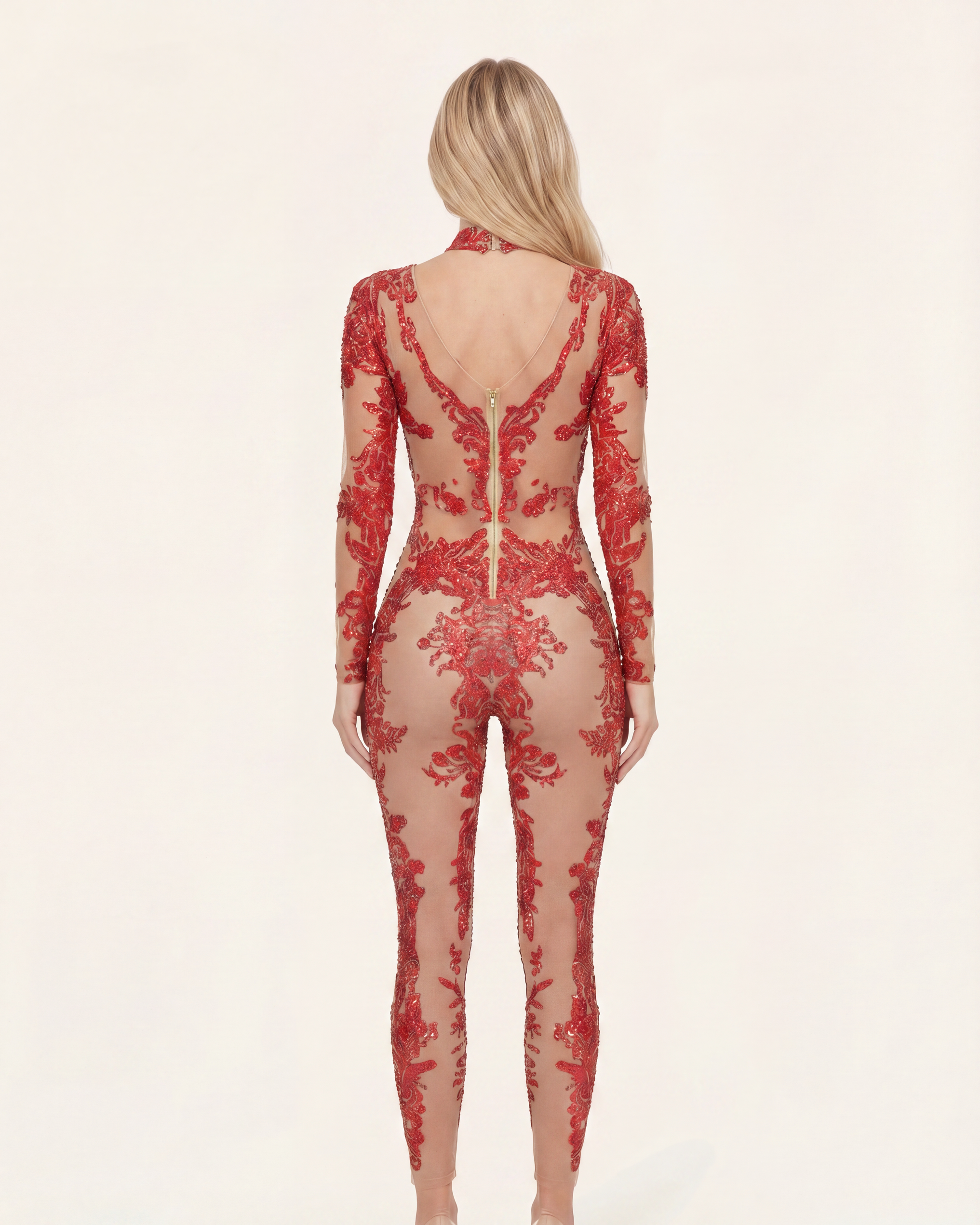 Back view of a red rhinestone and sequin jumpsuit with a sheer spandex base and concealed back zipper closure.