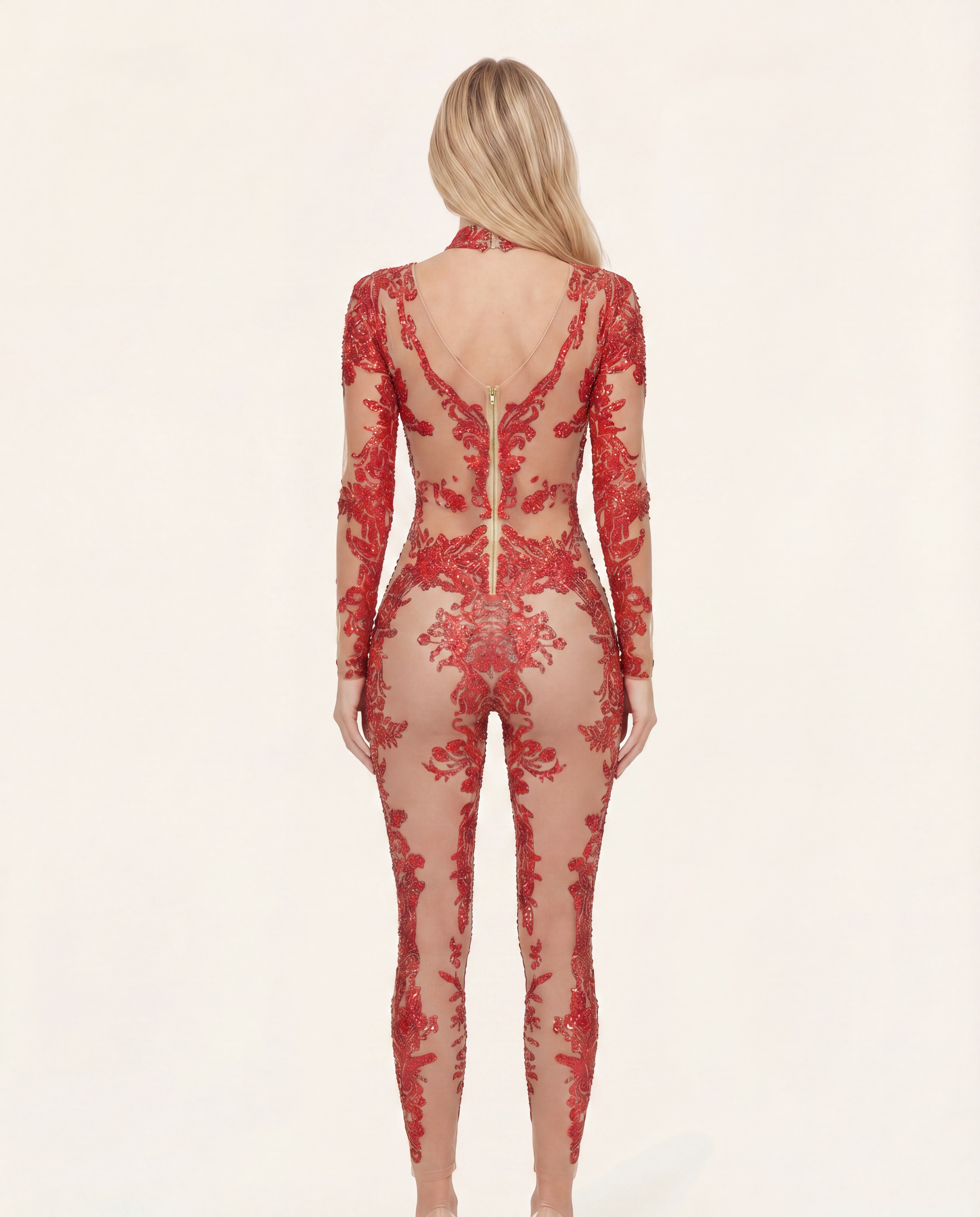 Back view of a red rhinestone and sequin jumpsuit with a sheer spandex base and concealed back zipper closure.