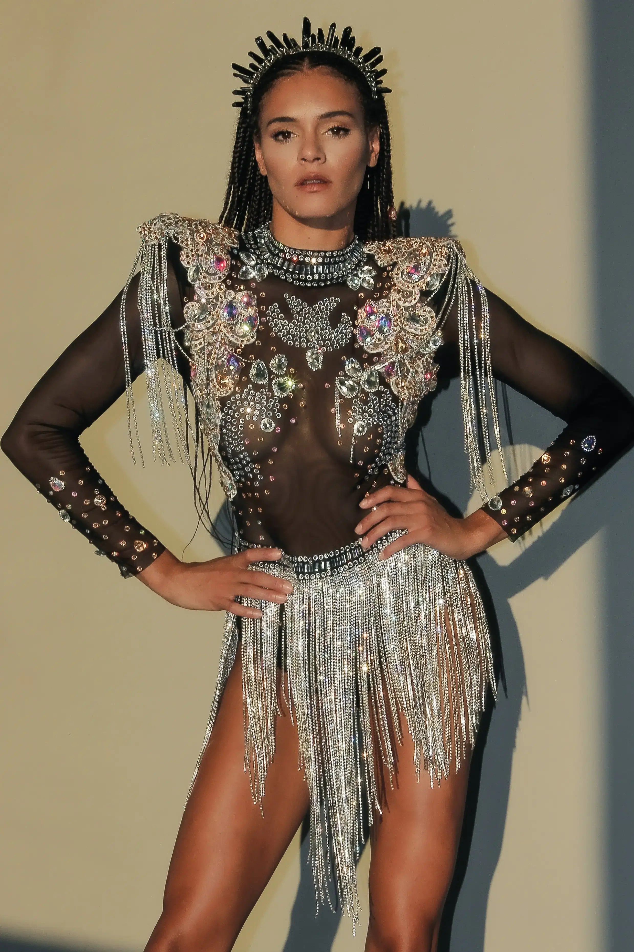 Rhinestone Tassel Festival Bodysuit featuring luxurious rhinestones and sequins with flowing tassels.