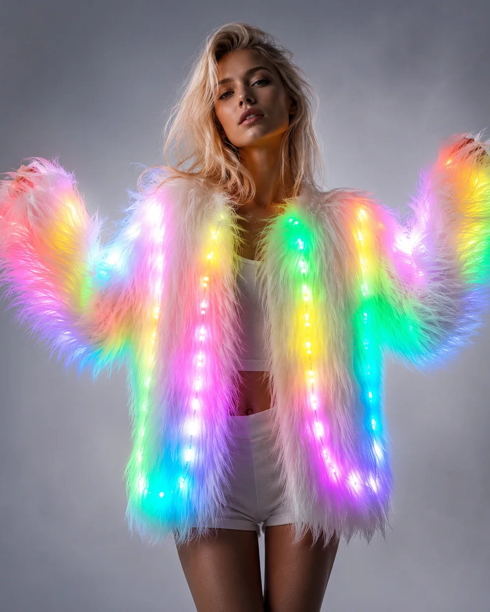 Woman wearing a plush white faux fur jacket featuring integrated, remote-controlled multicolored LED light strips.