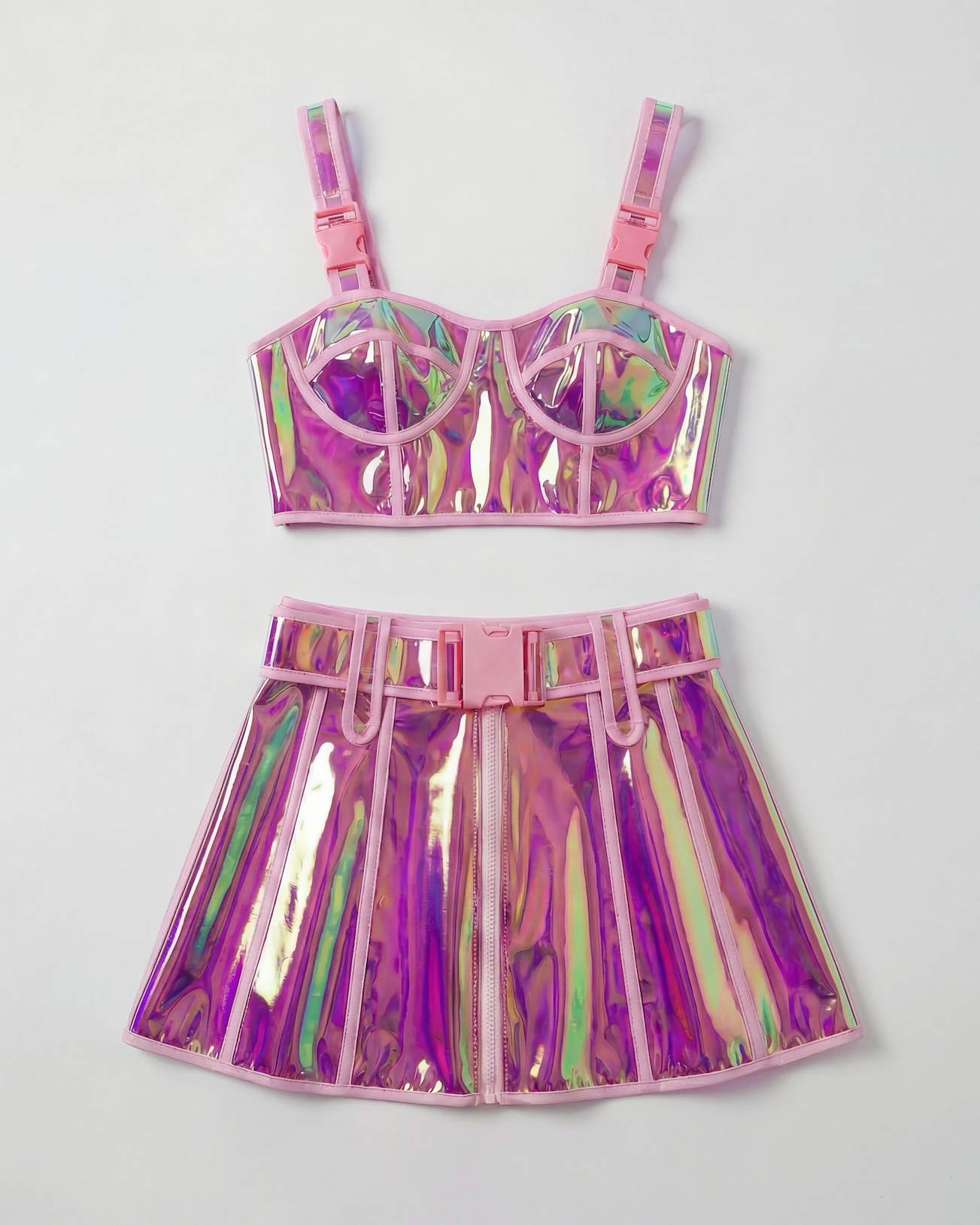 Pink reflective PVC crop top and mini skirt set with pink buckles and trim.