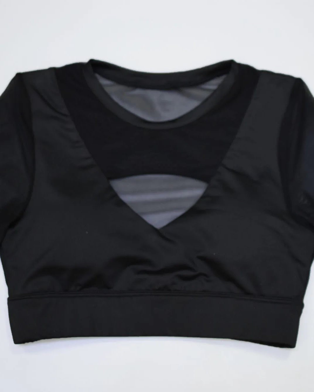 Short Sleeve Top with Sexy Cut in black, featuring a unique cut and soft fabric for a flirty look.