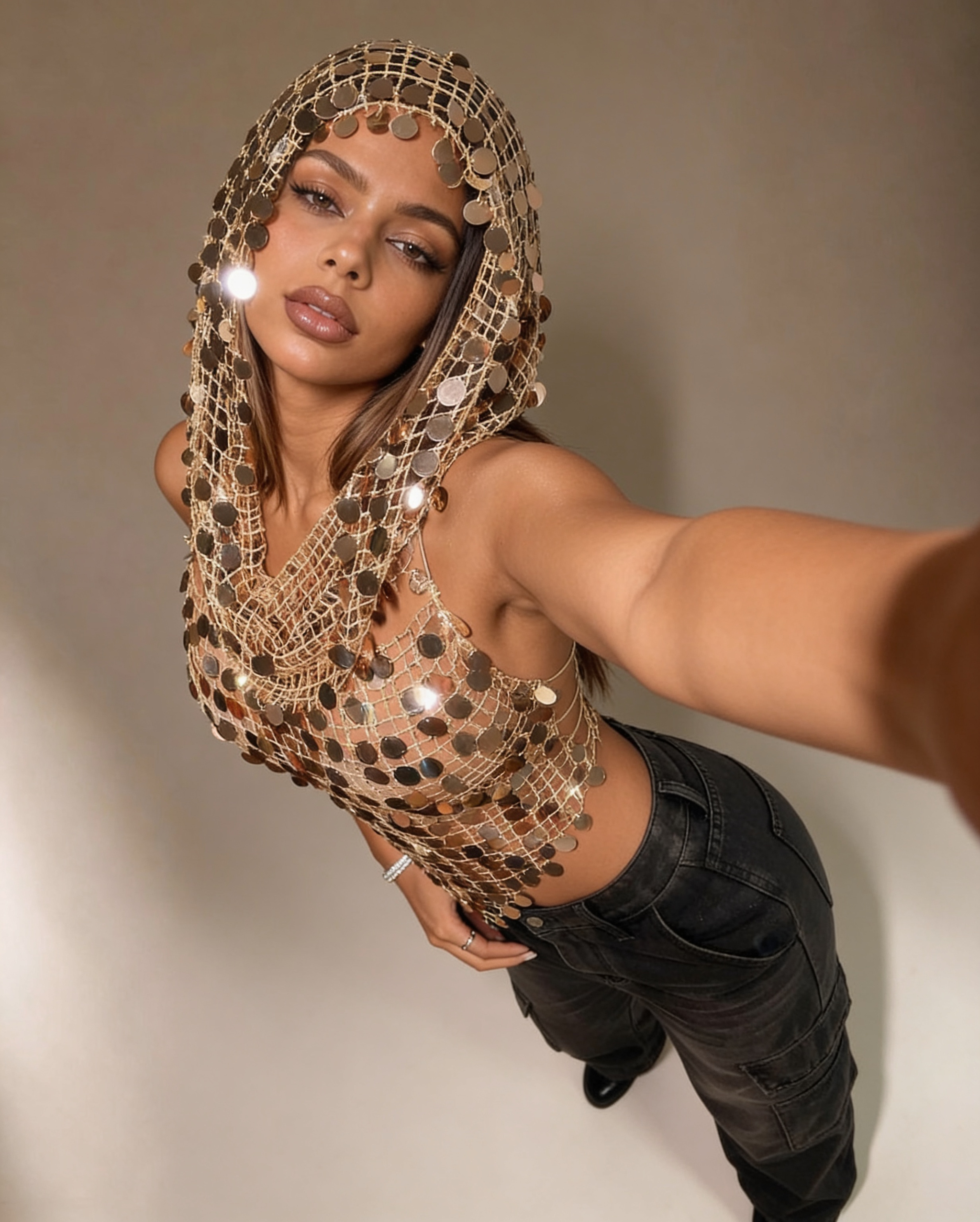 Gold sequin mesh hoodie top and matching high-waisted shorts set for festival wear.