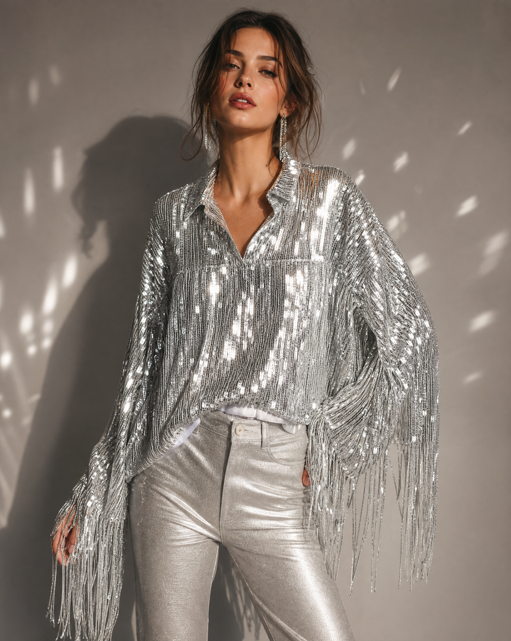 Silver sequin fringe jacket with long sleeves, worn by a model with metallic pants.