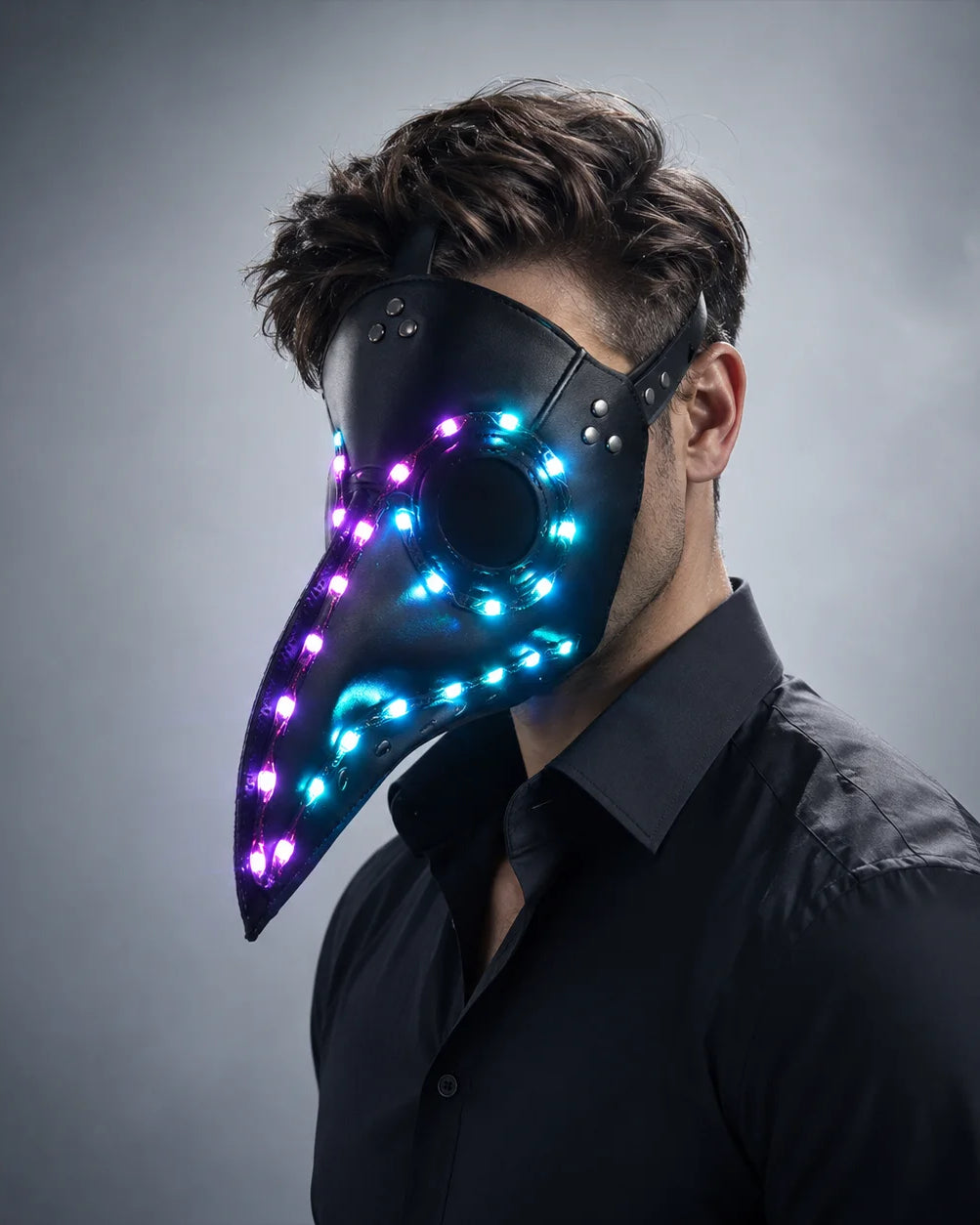 Black faux-leather plague doctor mask featuring glowing blue and purple LED lights, worn by a man in a black shirt.