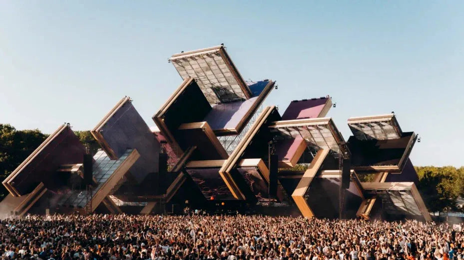 Awakenings Festival main stage with large geometric structures and a massive crowd under a clear sky.