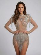 Nude long-sleeve bodysuit with iridescent rhinestones, sequins, and silver fringe tassels.