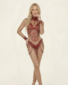 Blonde model in a sheer, form-fitting Aurora Red Rhinestone Jumpsuit with intricate red rhinestone embellishments.