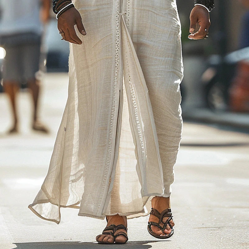 Close-up of a person wearing a light-colored, flowy dress and sandals, showcasing relaxed summer style.