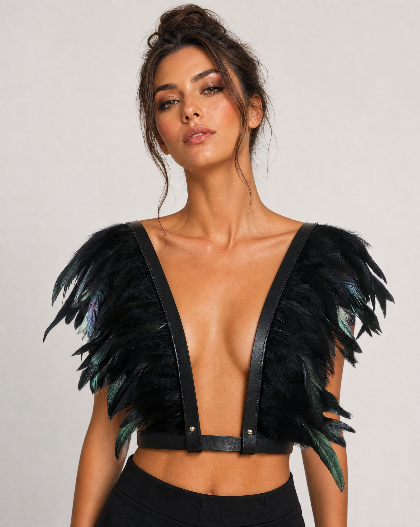 Black feather top with adjustable leather-look straps and a deep V-neck, worn by a model.