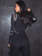 Back view of a woman wearing a Black Rave Bodysuit with mesh details and sleek design.