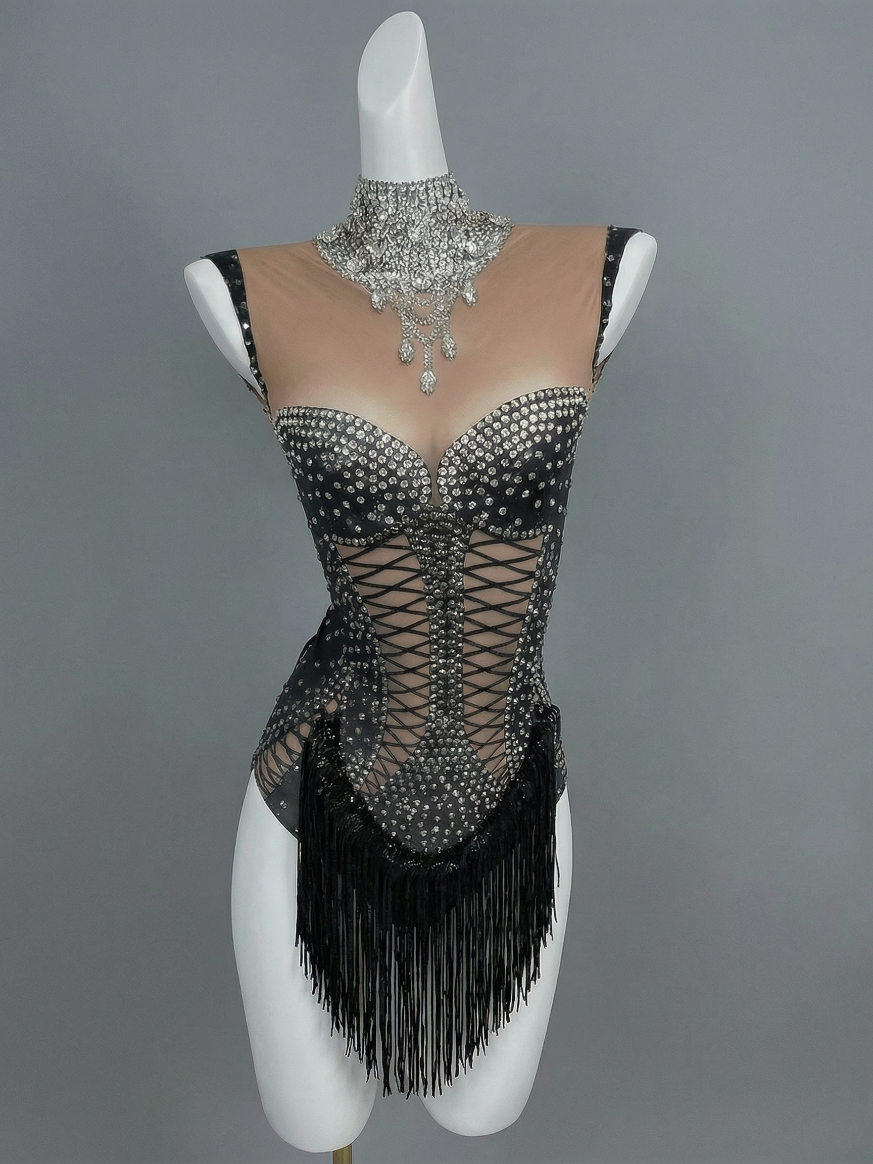 Black rhinestone tassel bodysuit with sheer mesh, corset lacing, and high neck embellishment.
