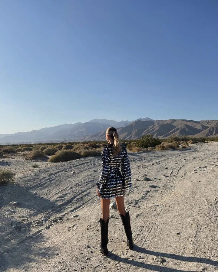 Model in Black Sequin Hollow-Out Mini Party Dress poses against mountain backdrop.