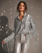 Silver sequin fringe jacket with long tassels, paired with metallic pants.