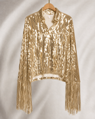 Gold sequin fringe jacket with long sleeves, hanging on a wooden hanger.