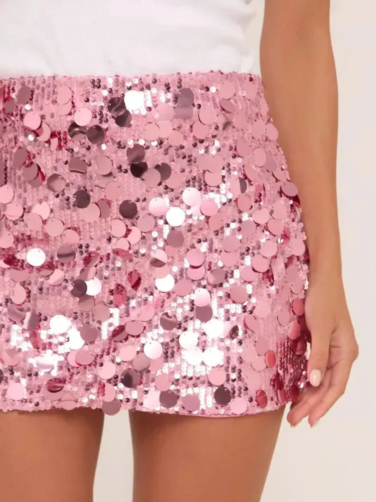 Pink sequin bodycon mini skirt, shimmering with all-over round sequins, worn by a model.