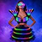 Model wearing a black LED tutu bra set with glowing shoulder pieces and matching light-up skirt against a purple background.