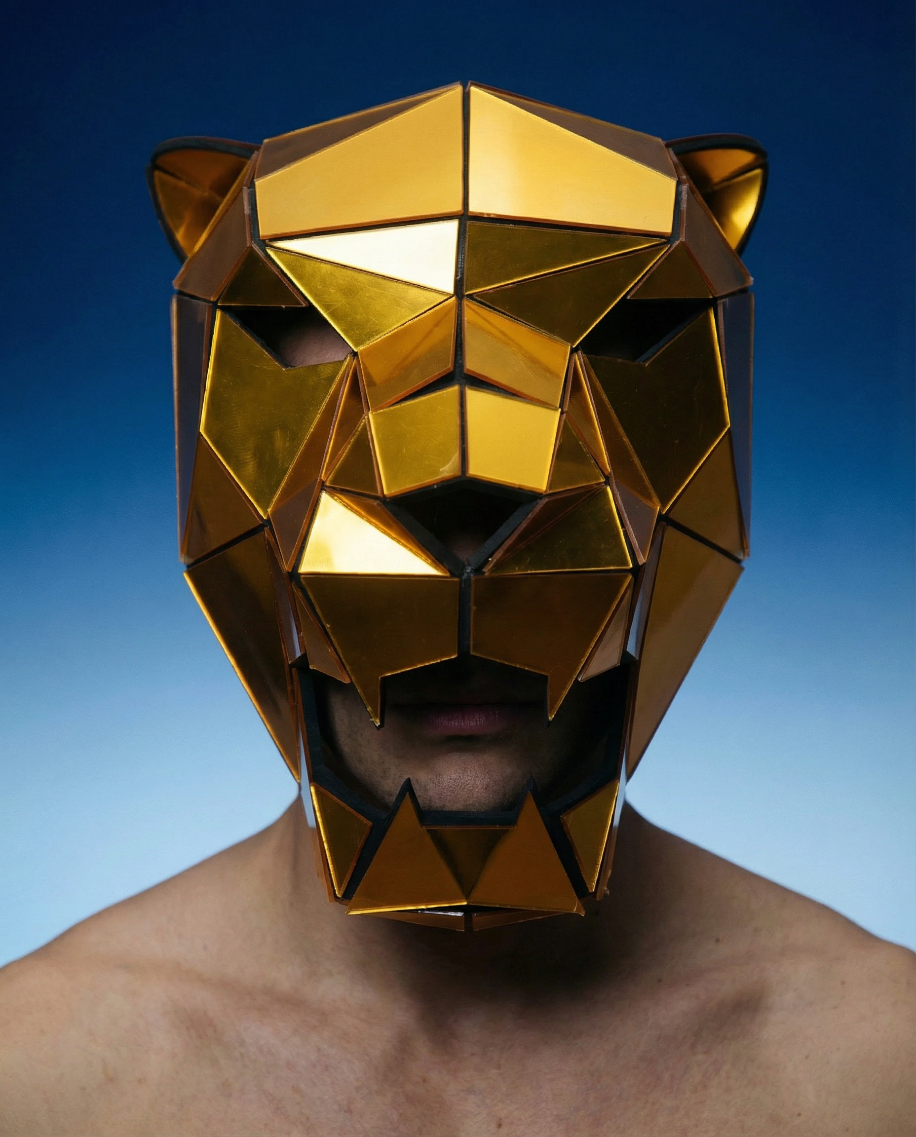 Gold geometric mirror tiger mask made from precision-cut acrylic panels, worn by a person.