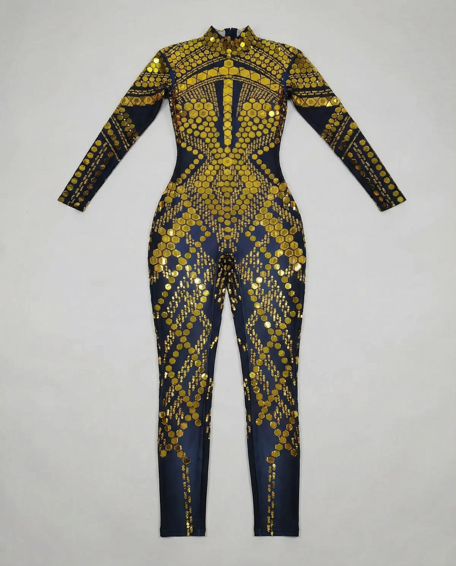 Gold sequin jumpsuit with a high neck and long sleeves, featuring a geometric pattern on dark fabric.